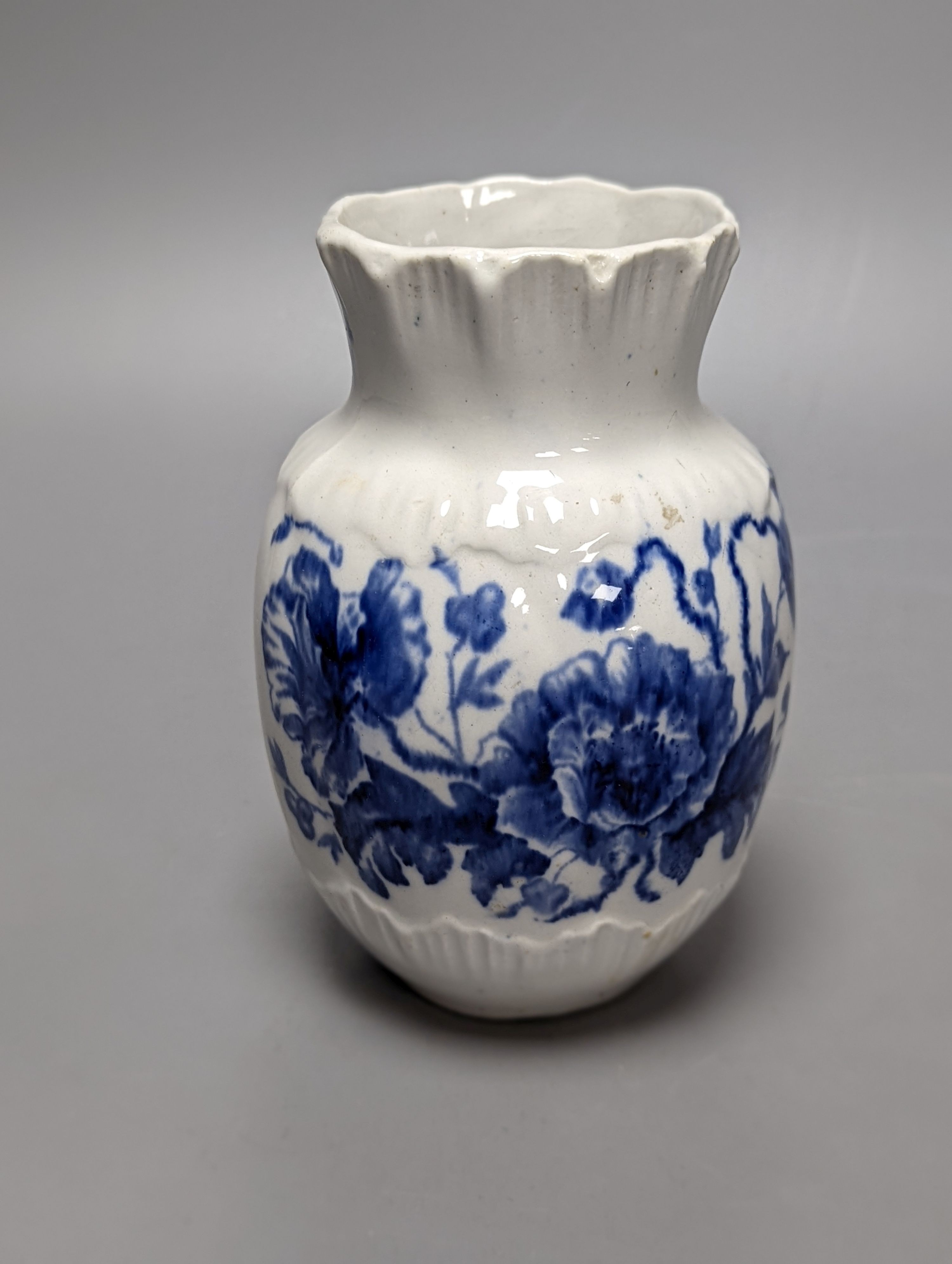 Four items of early 19th century blue and white pearlware pottery, an 18th century Delft blue and white vase and a 19th century toothbrush holder, Delft vase 22 cms high.